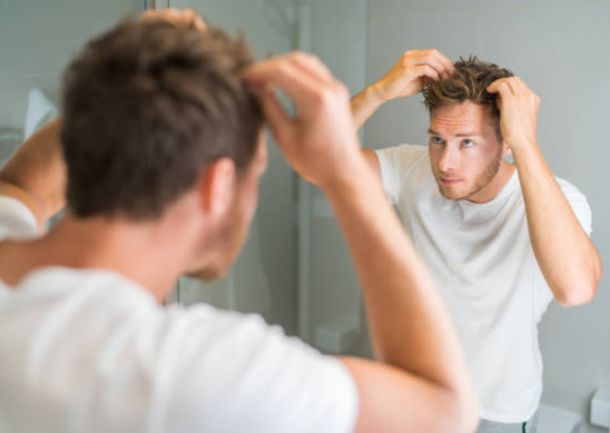 Men use hair wax sticks for styling