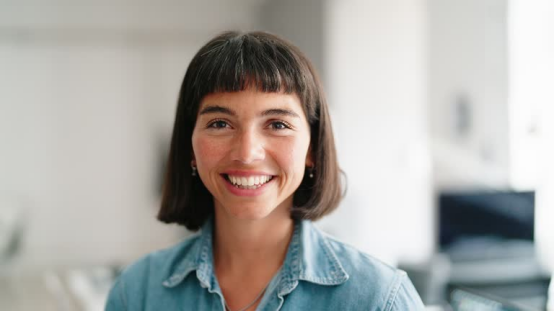 Short-haired woman with a polished style (one of the trendy looks achieved using a hair wax stick, living up to the "short hair, big impact" theme)